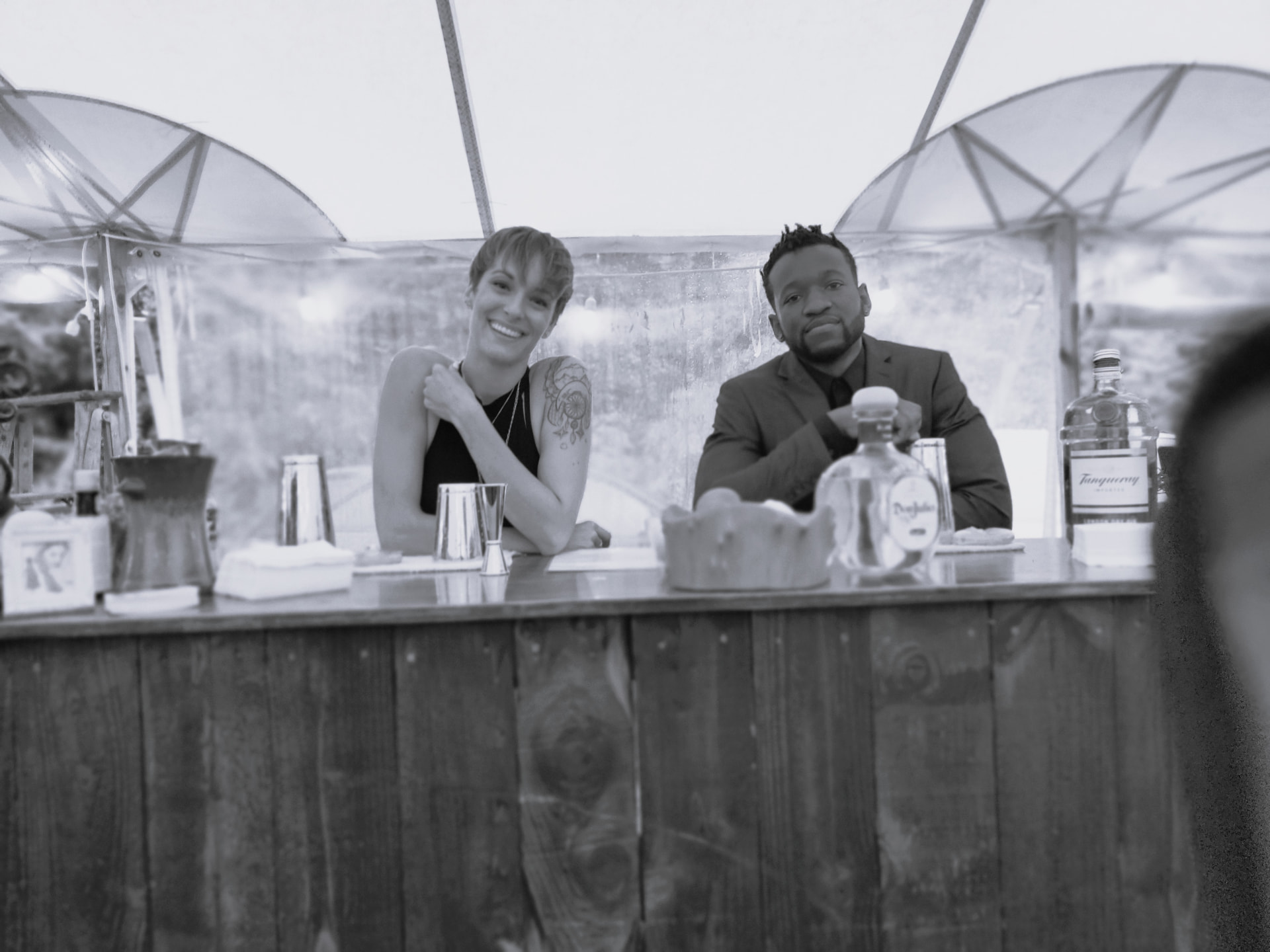Josh and Jaclyn hosting guests at an event bar
