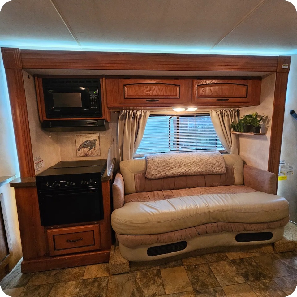 Coachman RV — kitchenette with stove, microwave and sofa