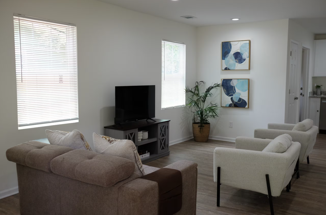Beltline Bungalow — living room with TV, plants and modern seating