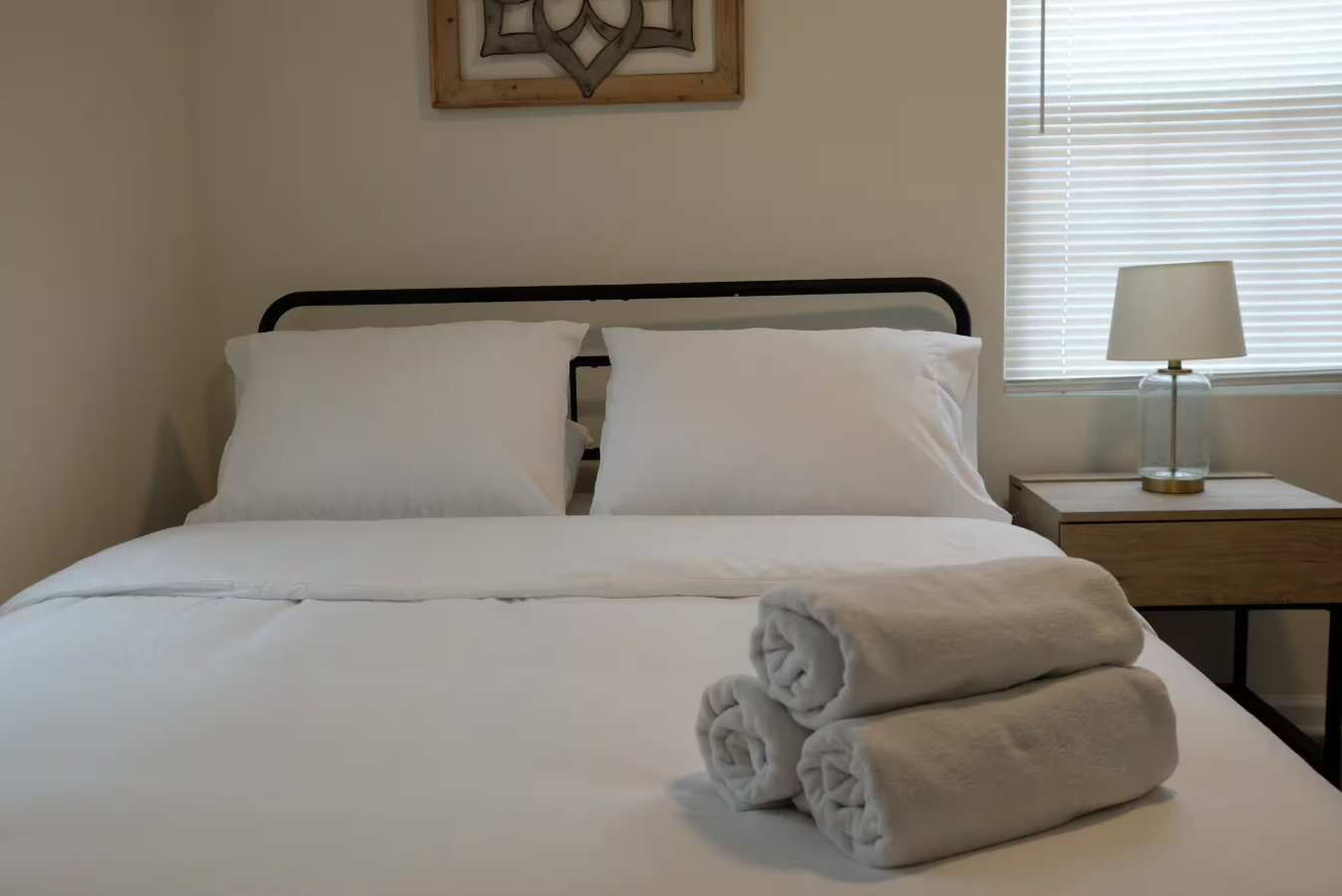 Beltline Bungalow — bedroom with framed wall art and nightstand