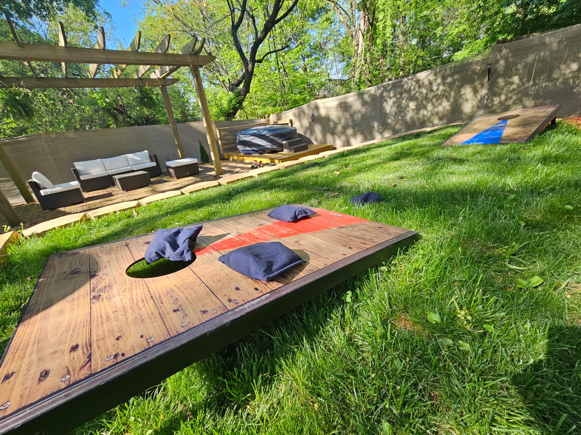 Urban Oasis — backyard lawn games and pergola lounge area