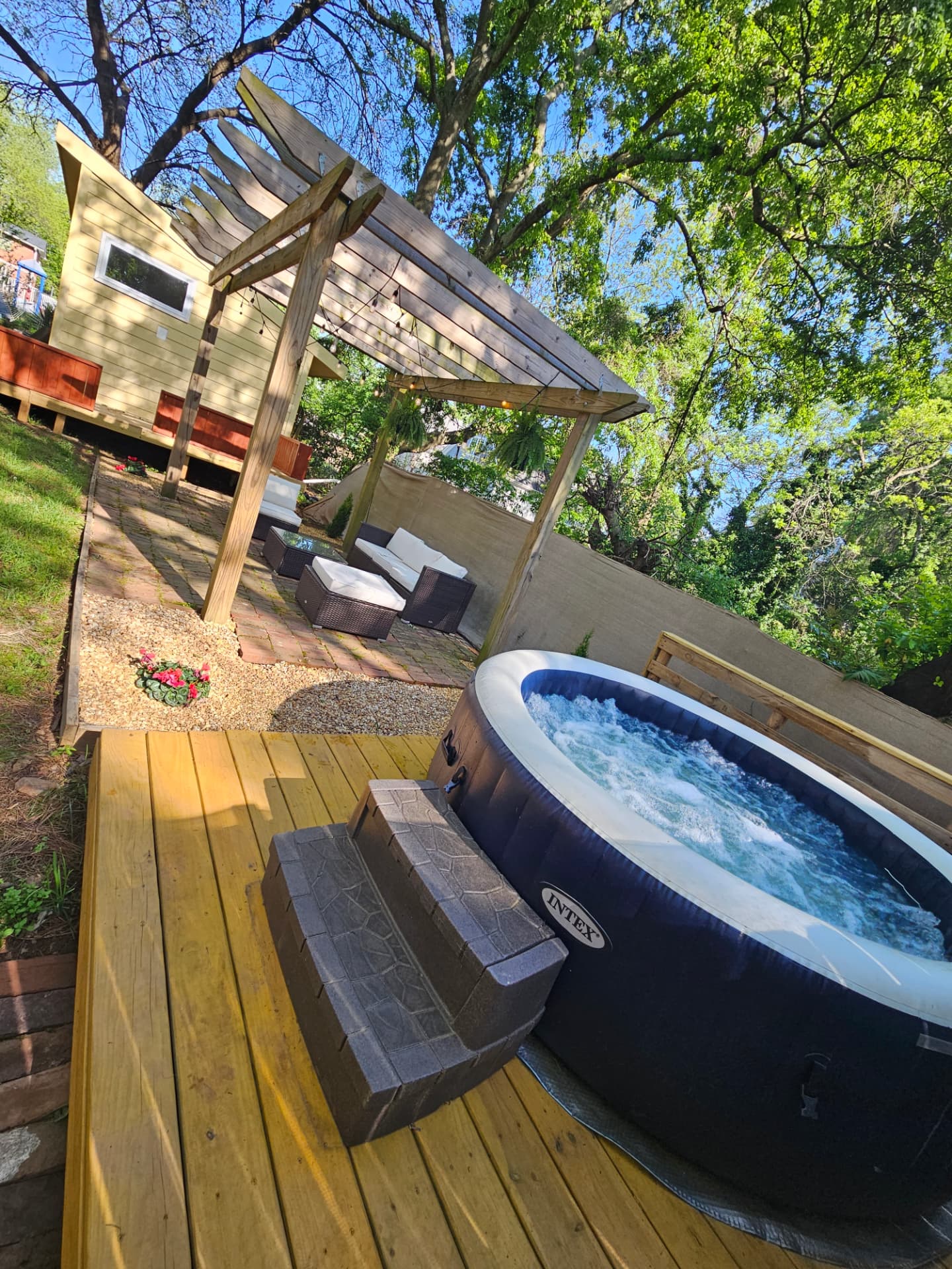 Urban Oasis — private hot tub under a wooden pergola