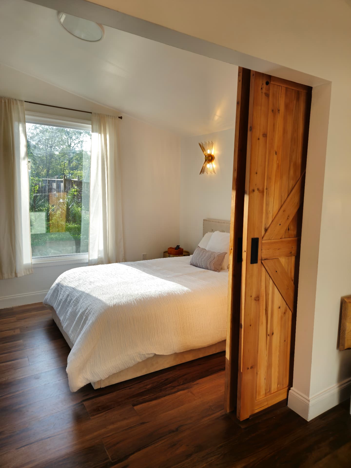 Urban Oasis — bedroom with sliding barn door