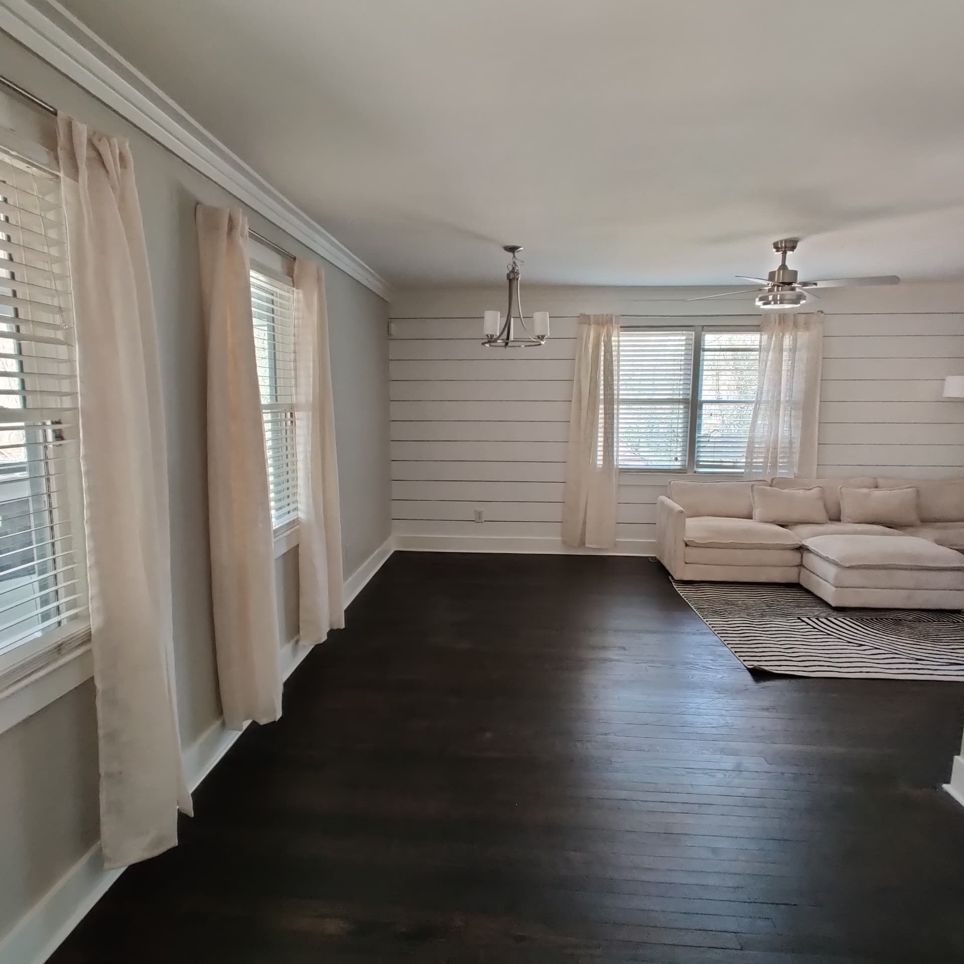 Gresham Park Getaway — bright living room with sectional and shiplap walls