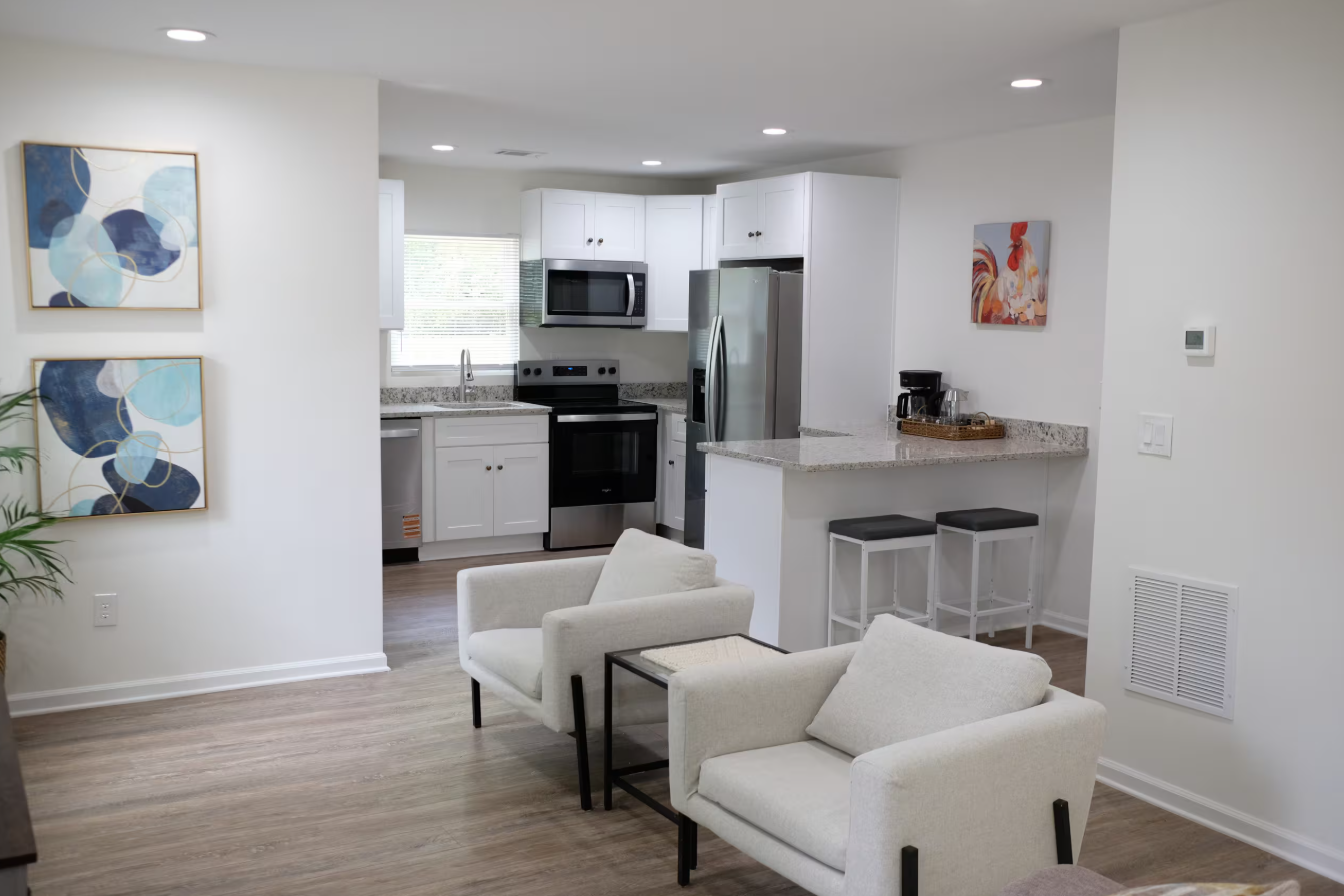 Beltline Bungalow — kitchen and breakfast bar with white cabinetry